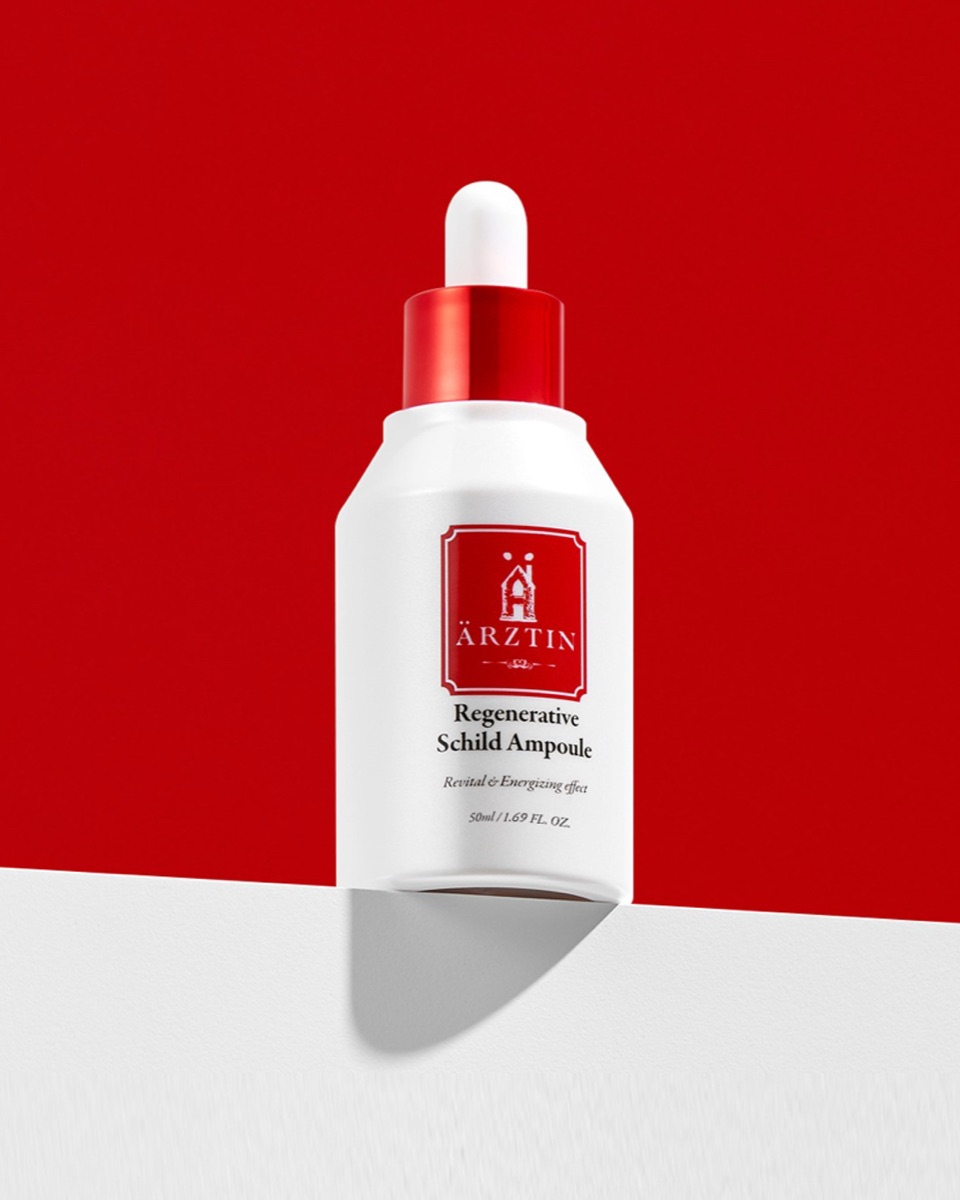 Ärztin Regenerative Schild Ampoule dropper bottle on a red backdrop